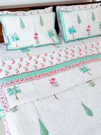 Palm and Pink Floral quilted bedcover detail showing palm and floral motifs.