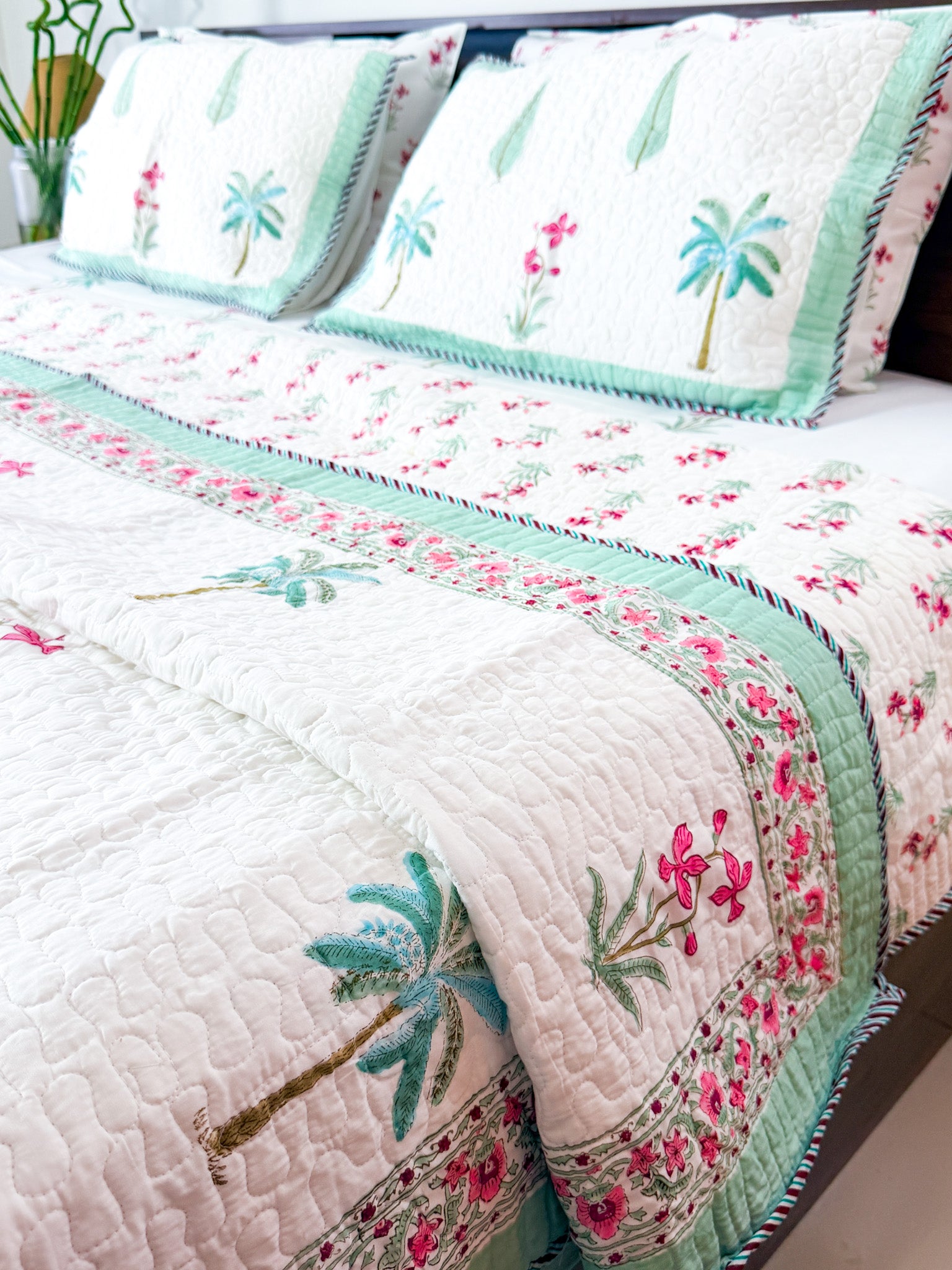 Palm and Pink Floral quilted bedcover styled product view.