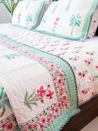 Palm and Pink Floral quilted bedcover detail with mint border.