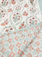 Reversible floral and geometric print detail of ORA Living Sage and Rust Floral Handblock Reversible Pure Mulmul Cotton Quilt