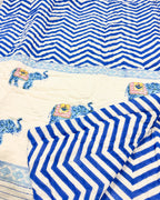 Close-up of the blue chevron and elephant print on ORA Living's reversible Pure Mulmul Cotton Quilt