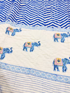 Detail of the elephant motif and blue chevron border on ORA Living's reversible Pure Mulmul Cotton Quilt
