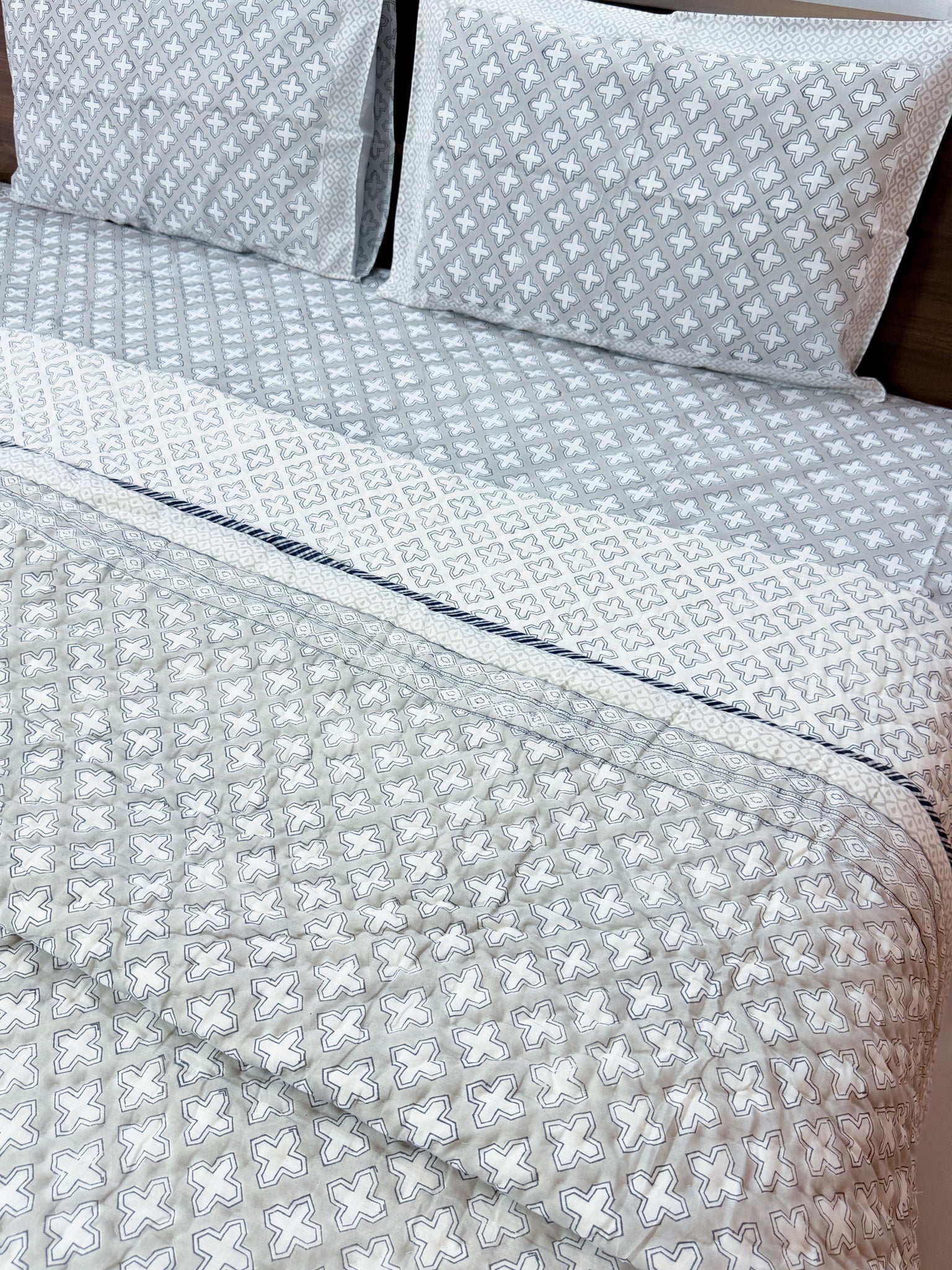 ORA Living Grey Cross Handblock Reversible Pure Mulmul Cotton Quilt styled on a bed
