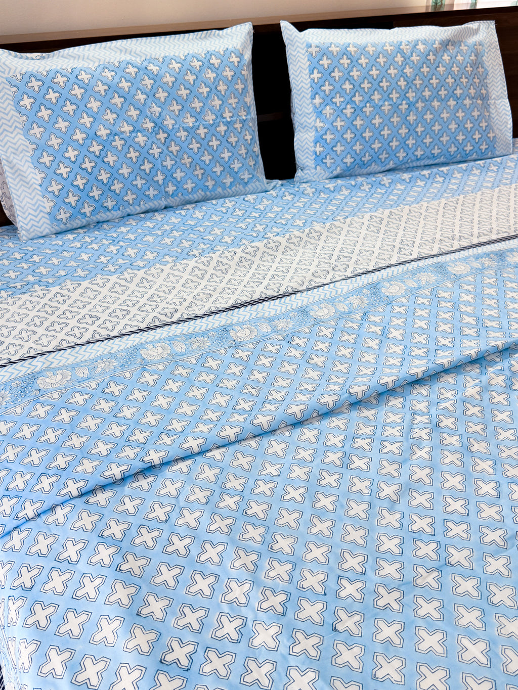 ORA Living Blue Cross Handblock Reversible Pure Mulmul Cotton Dohar styled on a bed