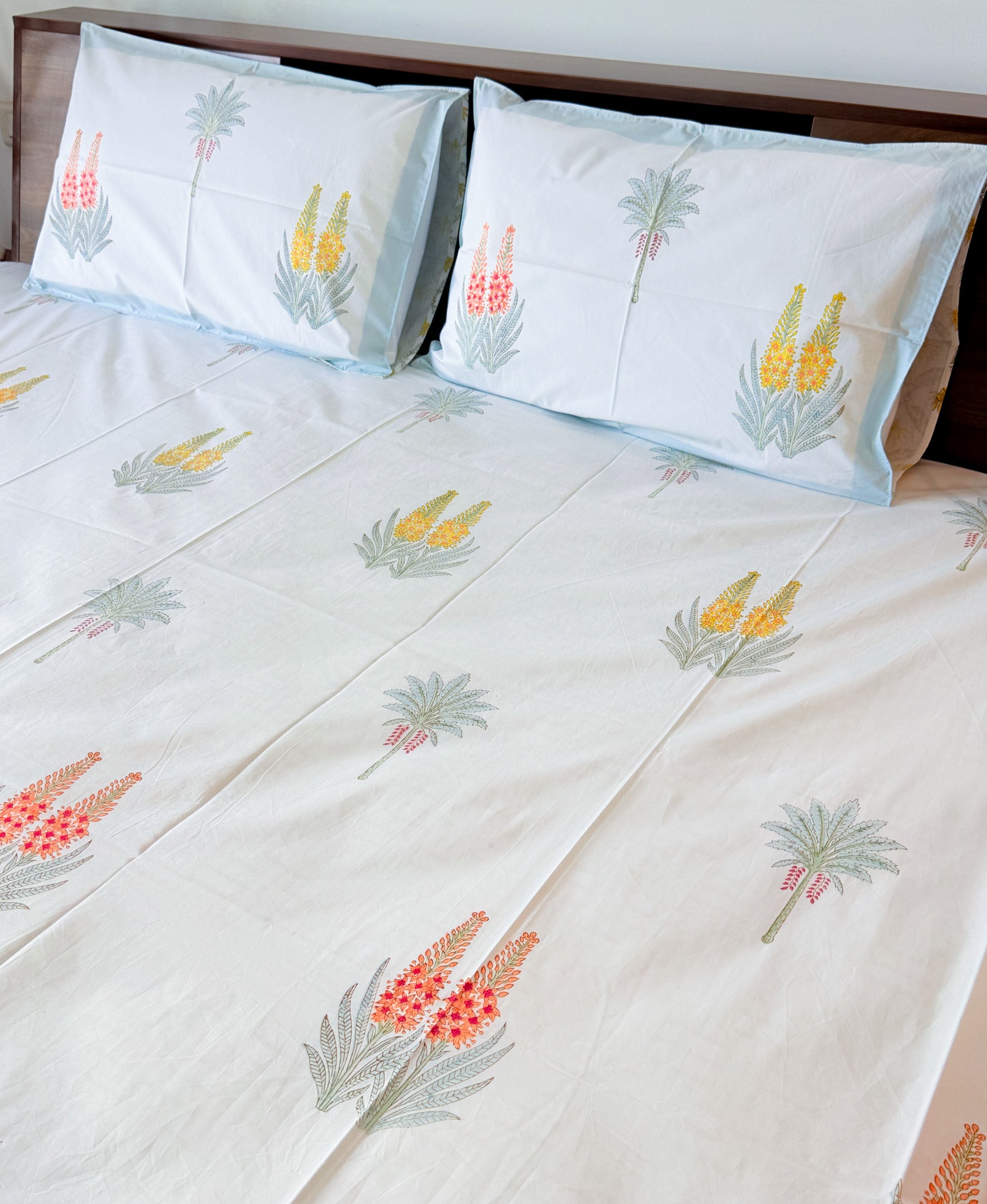 ORA Living Red Yellow Wildflower Handblock Premium Cotton Bedsheet Set styled on a bed