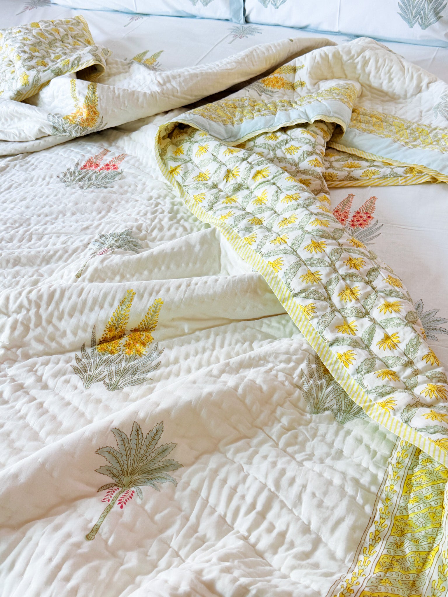 ORA Living Red Yellow Wildflower Handblock Reversible Pure Mulmul Cotton Quilt shown with both printed sides