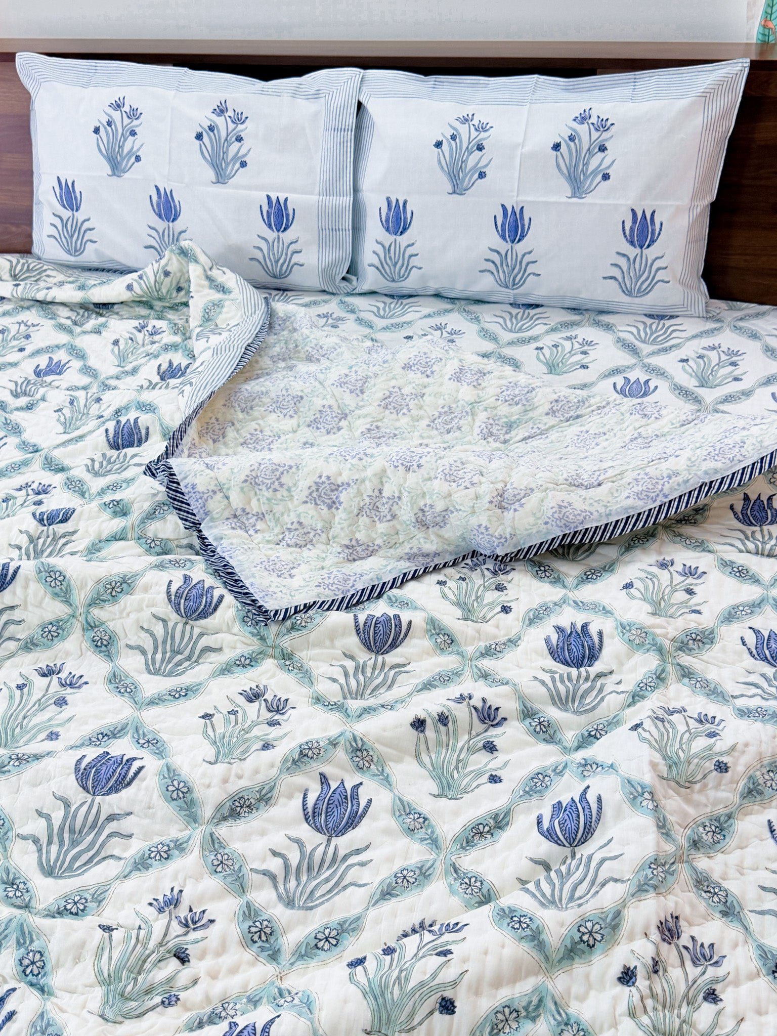 ORA Living Blue Flower Sage Leaf Handblock Reversible Pure Mulmul Cotton Quilt shown with both printed sides
