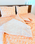 ORA Living Orange White Floral Handblock Reversible Pure Mulmul Cotton Quilt shown with both printed sides