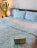 ORA Living Sky Blue White Bloom Handblock Reversible Pure Mulmul Cotton Quilt shown with both printed sides