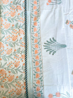 Close product view of the Orange Floral and Green Leaf hand-block dohar border and floral print.