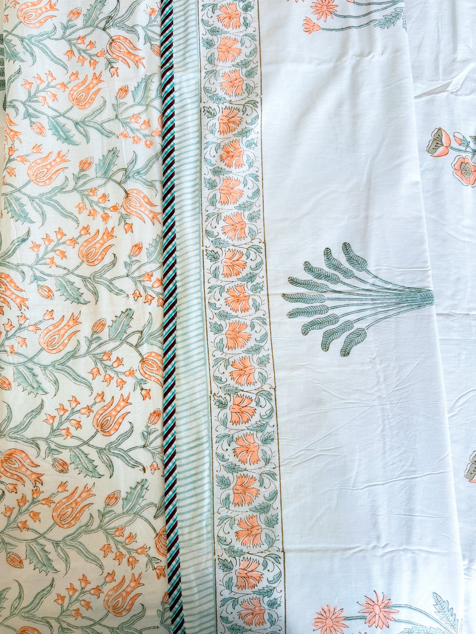 Close product view of the Orange Floral and Green Leaf hand-block dohar border and floral print.