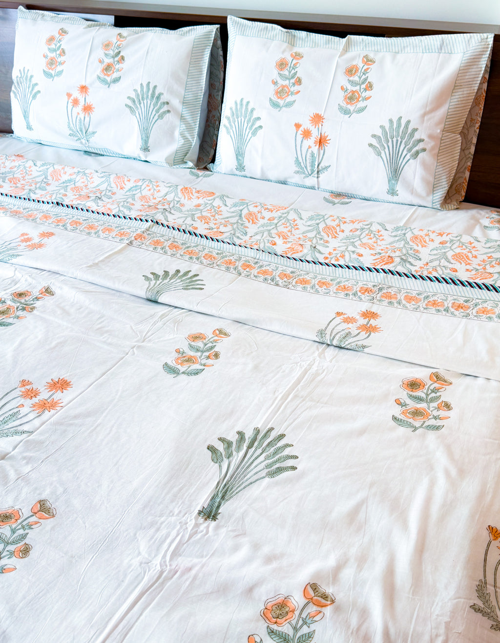 Detail view of the Orange Floral and Green Leaf hand-block dohar with orange flowers and green leafy motifs.