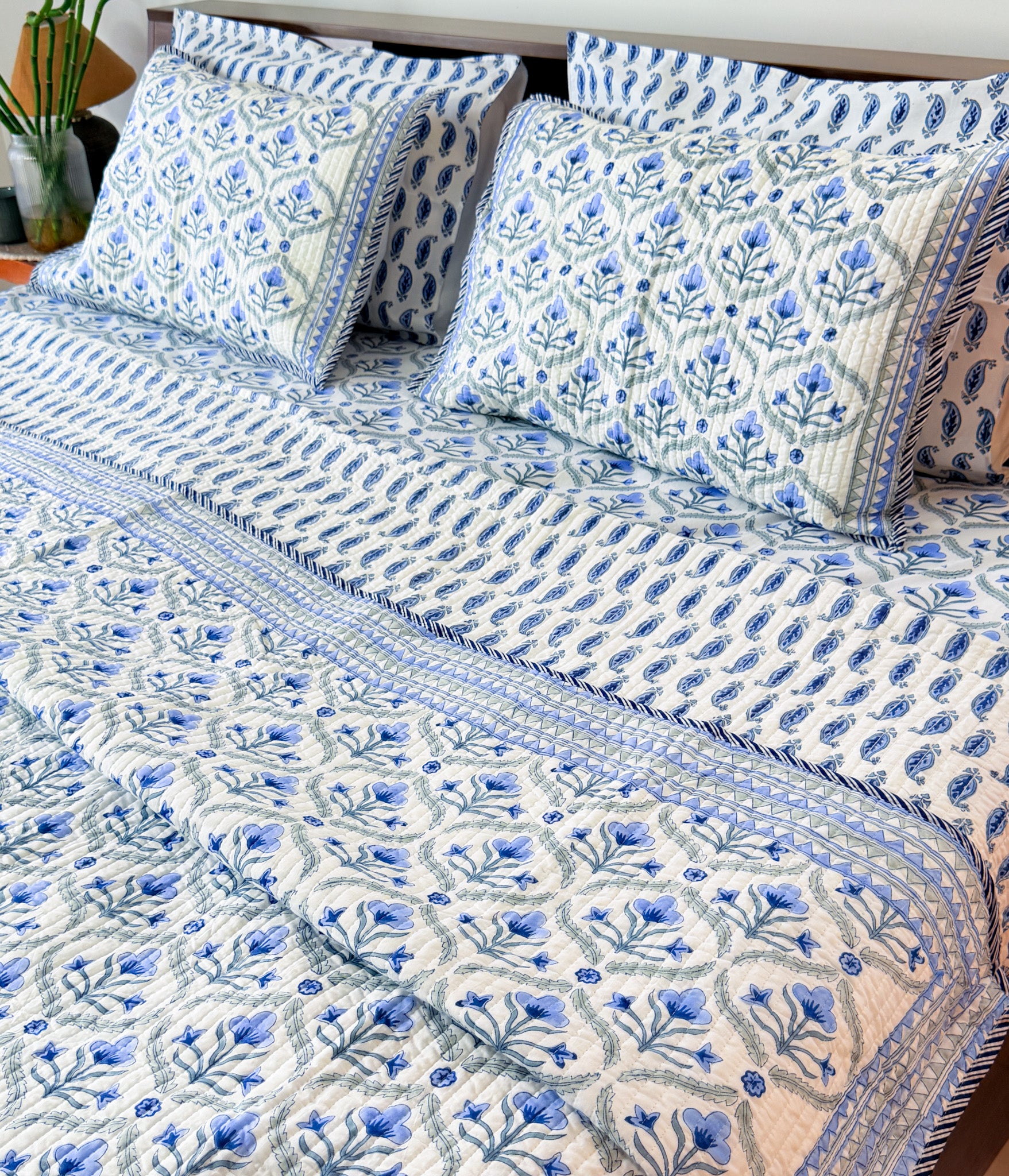 Blue Floral Butta quilted bedcover showing the blue floral print.