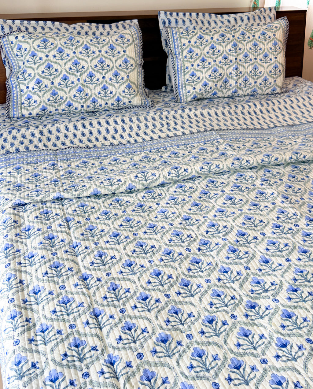 Blue Floral Butta quilted bedcover detail view.