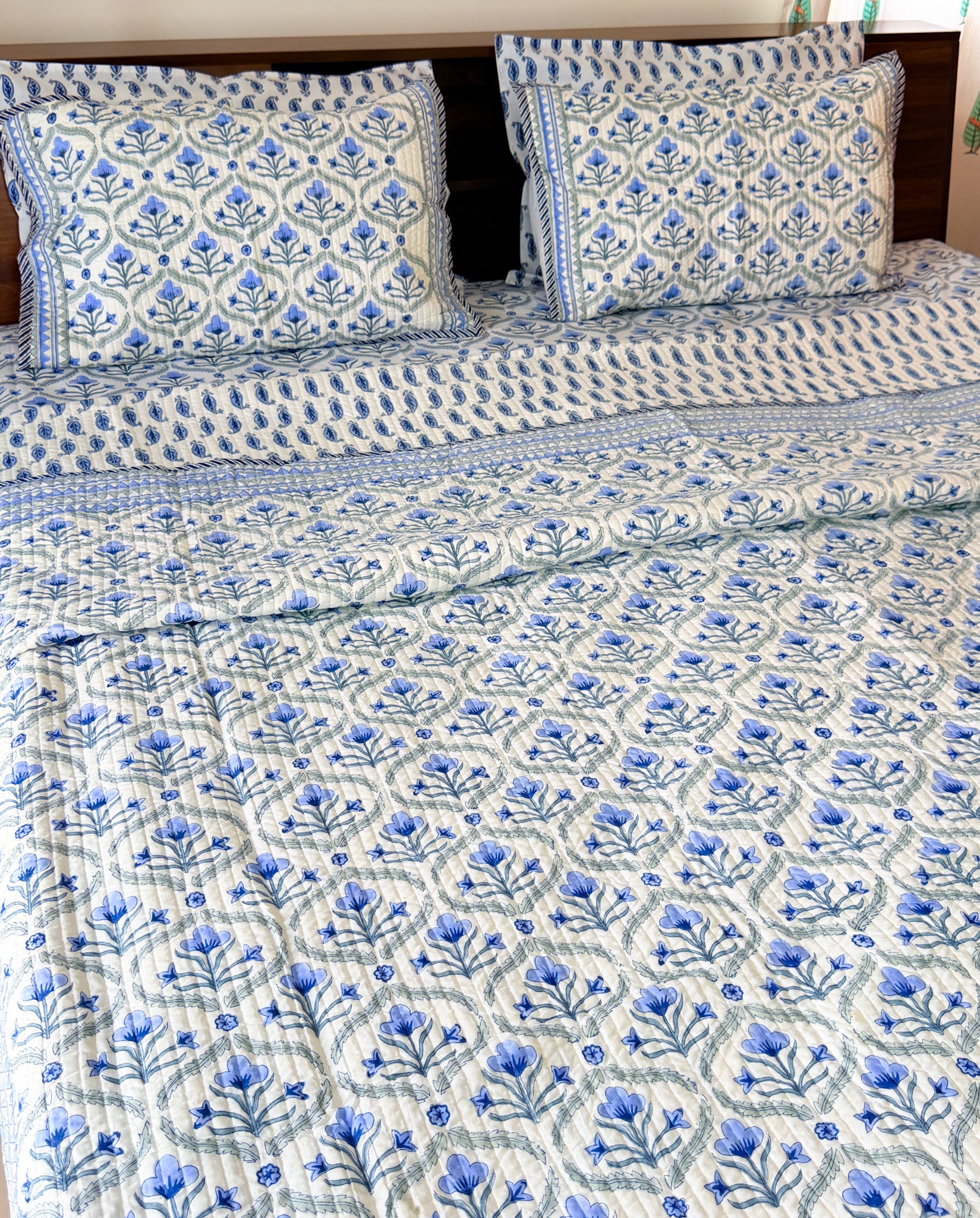 Blue Floral Butta quilted bedcover detail view.