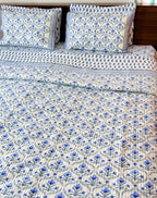 Blue Floral Butta quilted bedcover styled bed view.